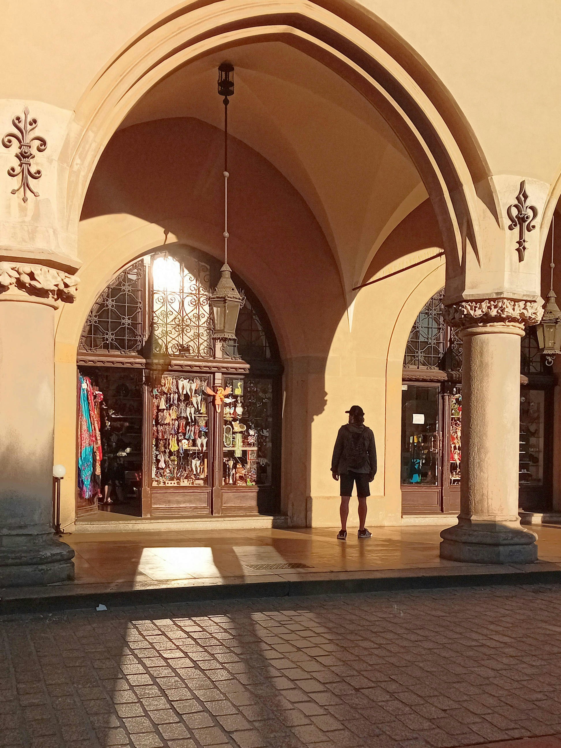 A man is standing in front of a building