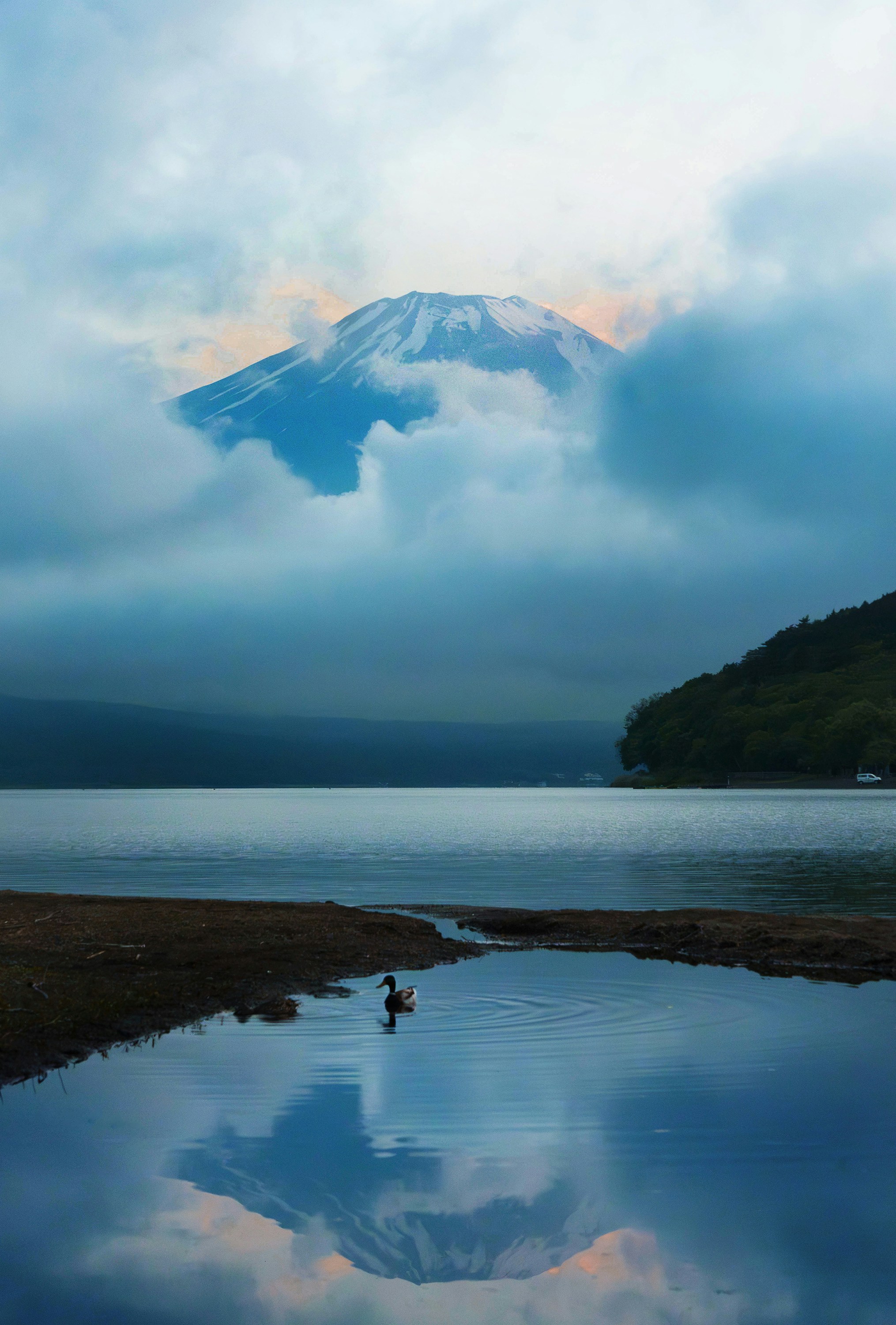 A large body of water with a mountain in the background
