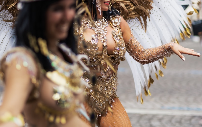 A couple of women that are standing in the street