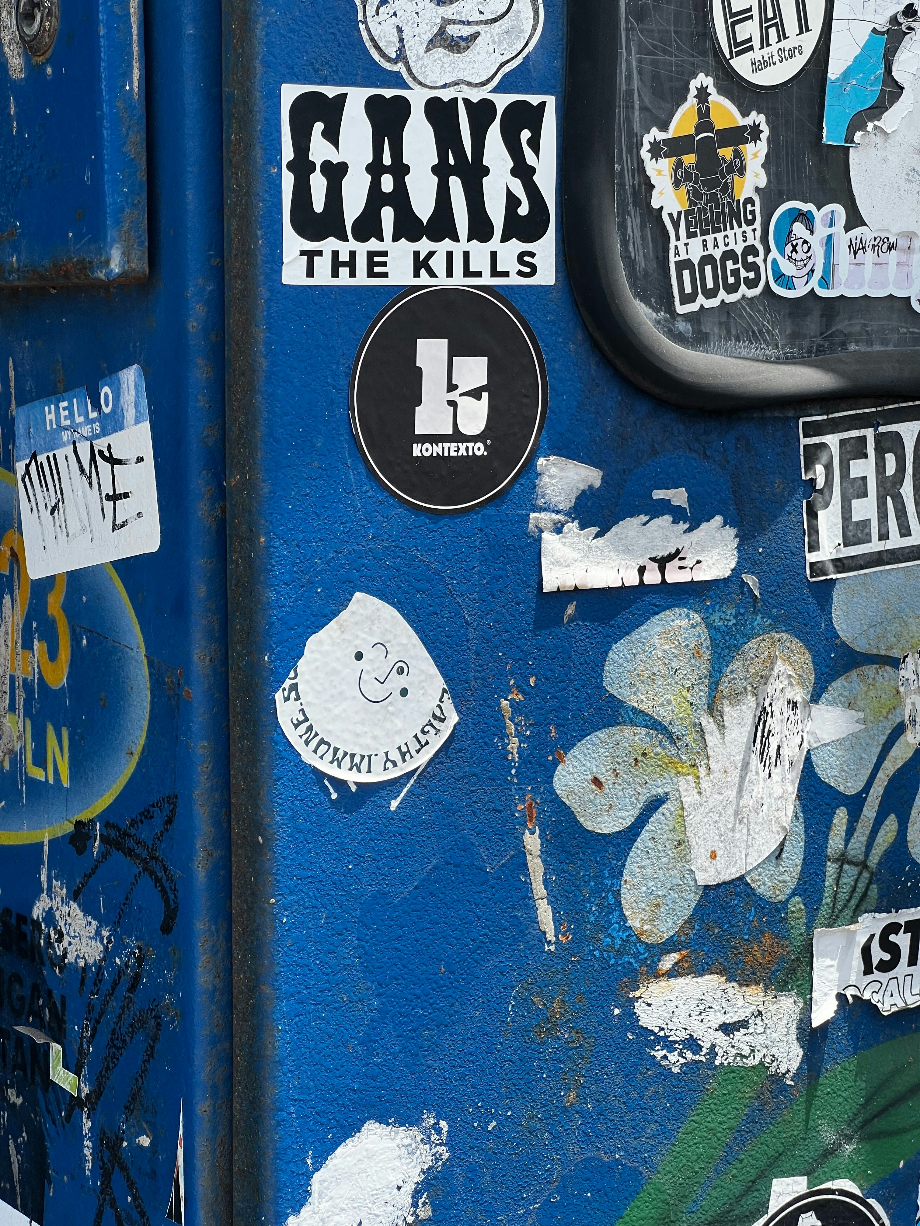 A bunch of stickers on the side of a building