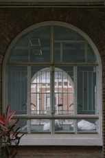 A brick building with a large arched window