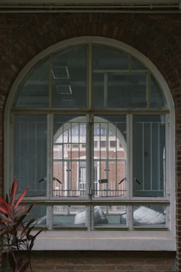 A brick building with a large arched window