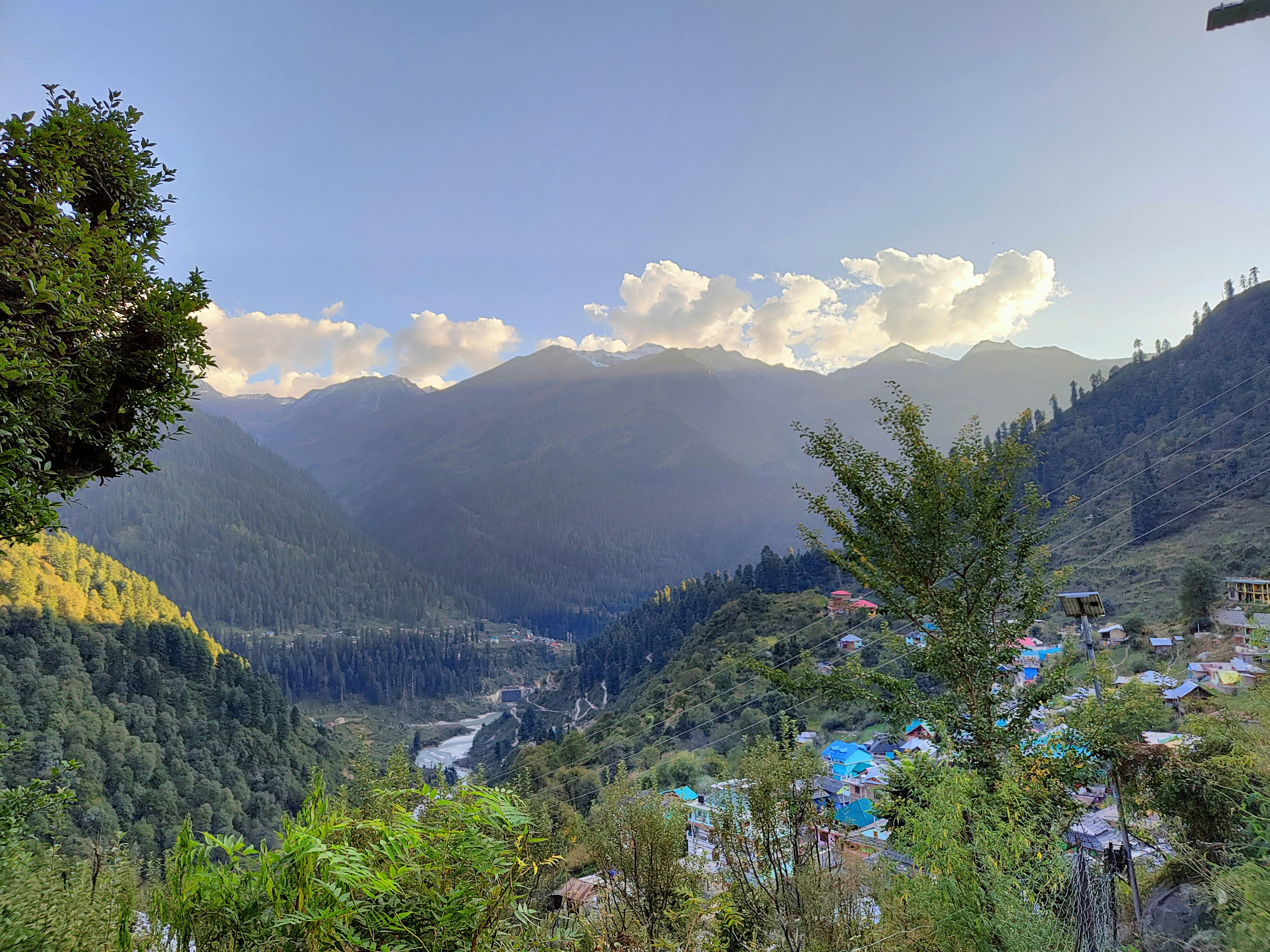 Krishna Homestay with traditional wooden architecture, flower gardens, and mountain backdrop in Uttarakhand village