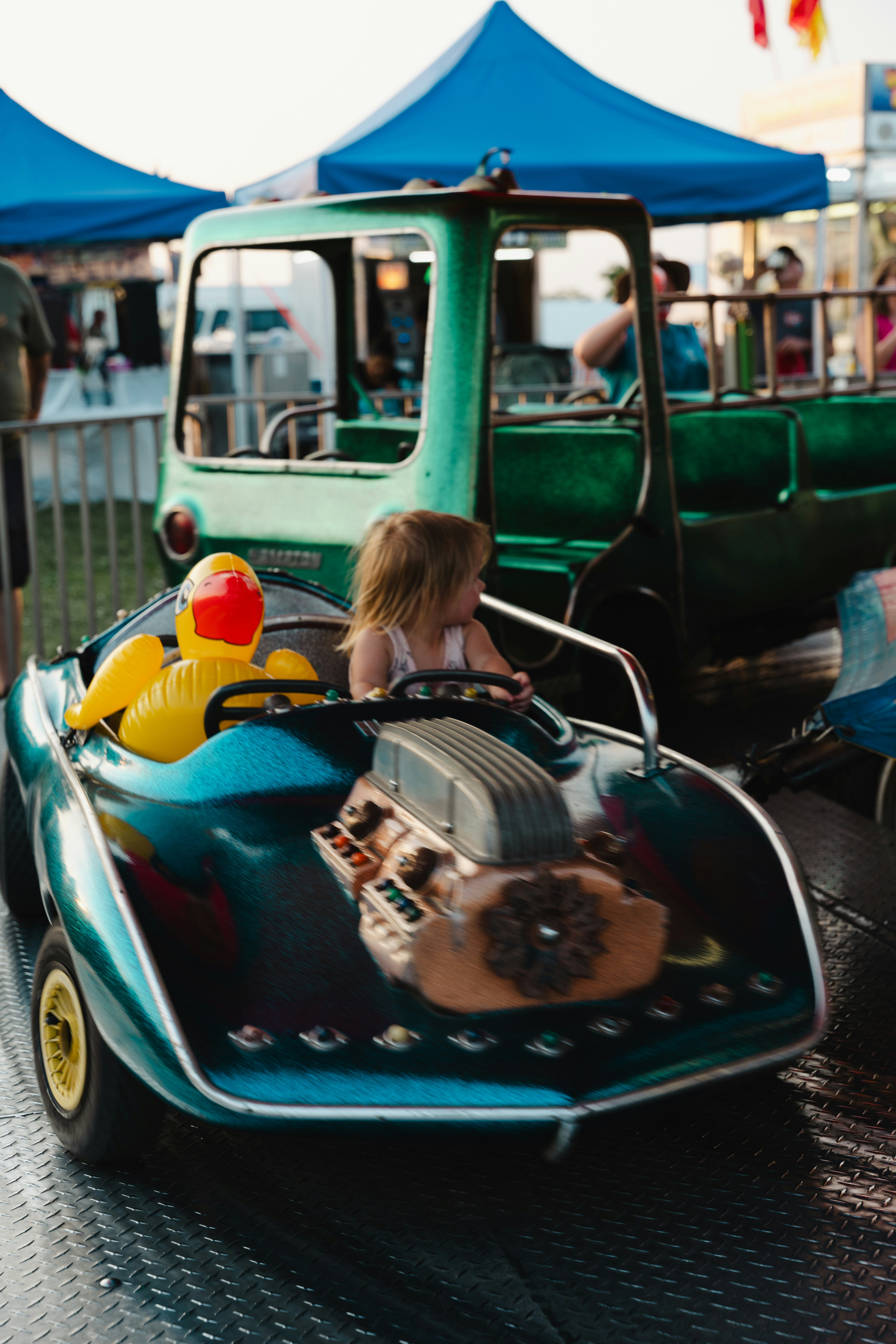 Toddler enjoying a colorful ride-on car