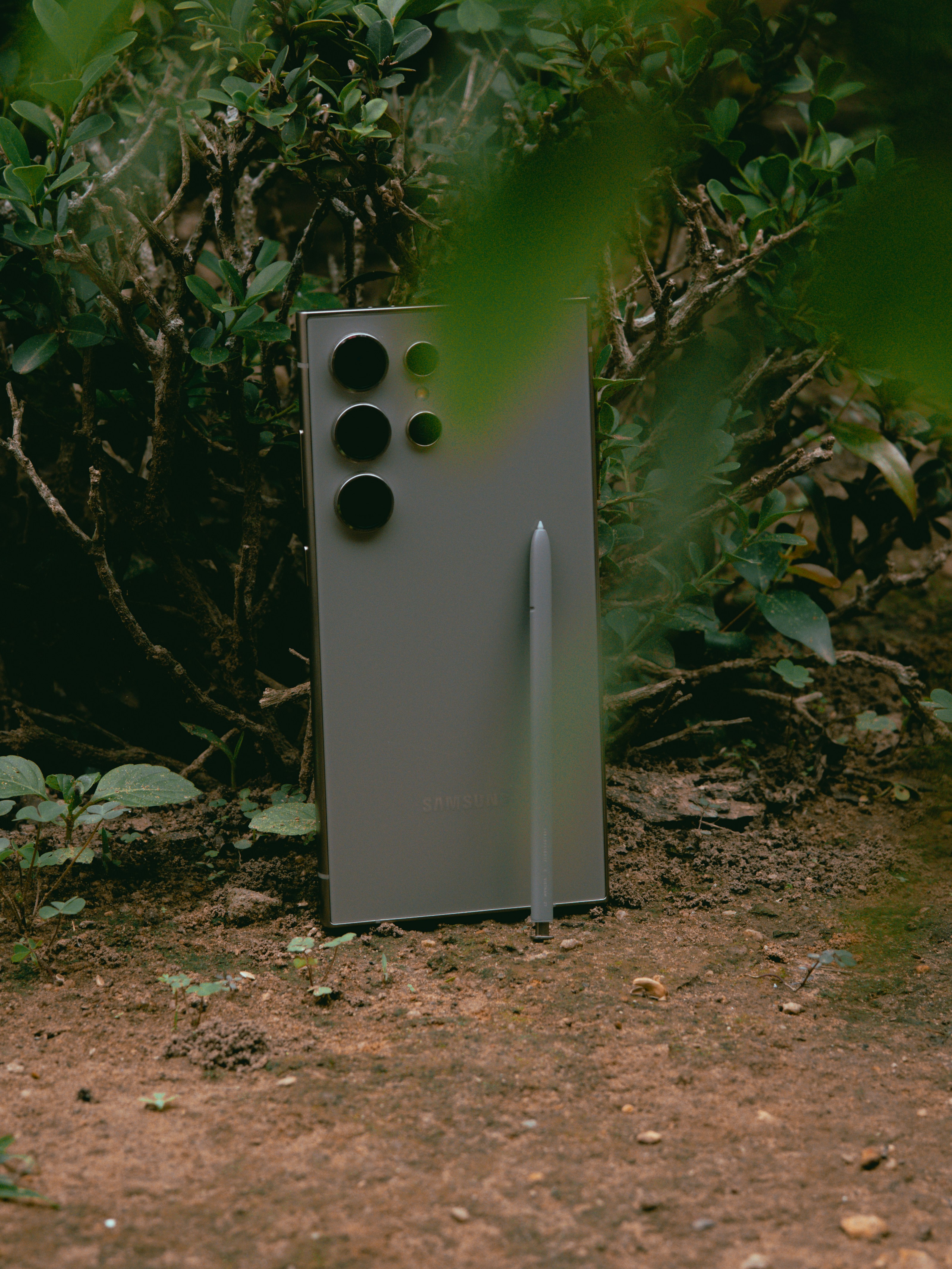 A tall metal object sitting in the middle of a forest