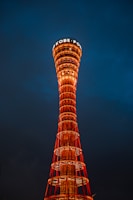A tall tower with a sign on top of it