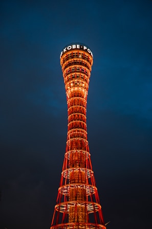 A tall tower with a sign on top of it