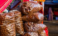 A pile of bags of food sitting on top of a table
