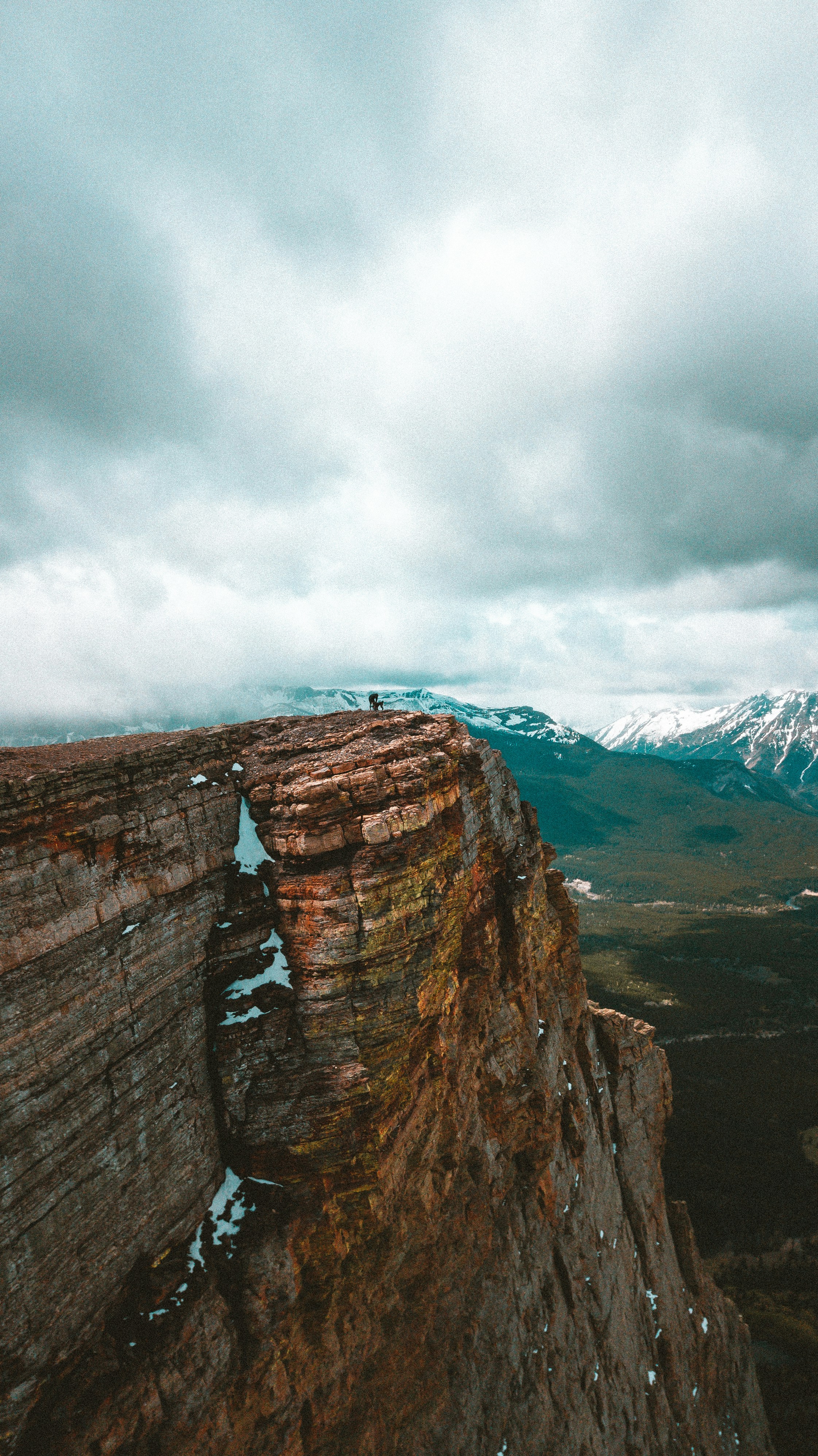 A person standing on top of a cliff