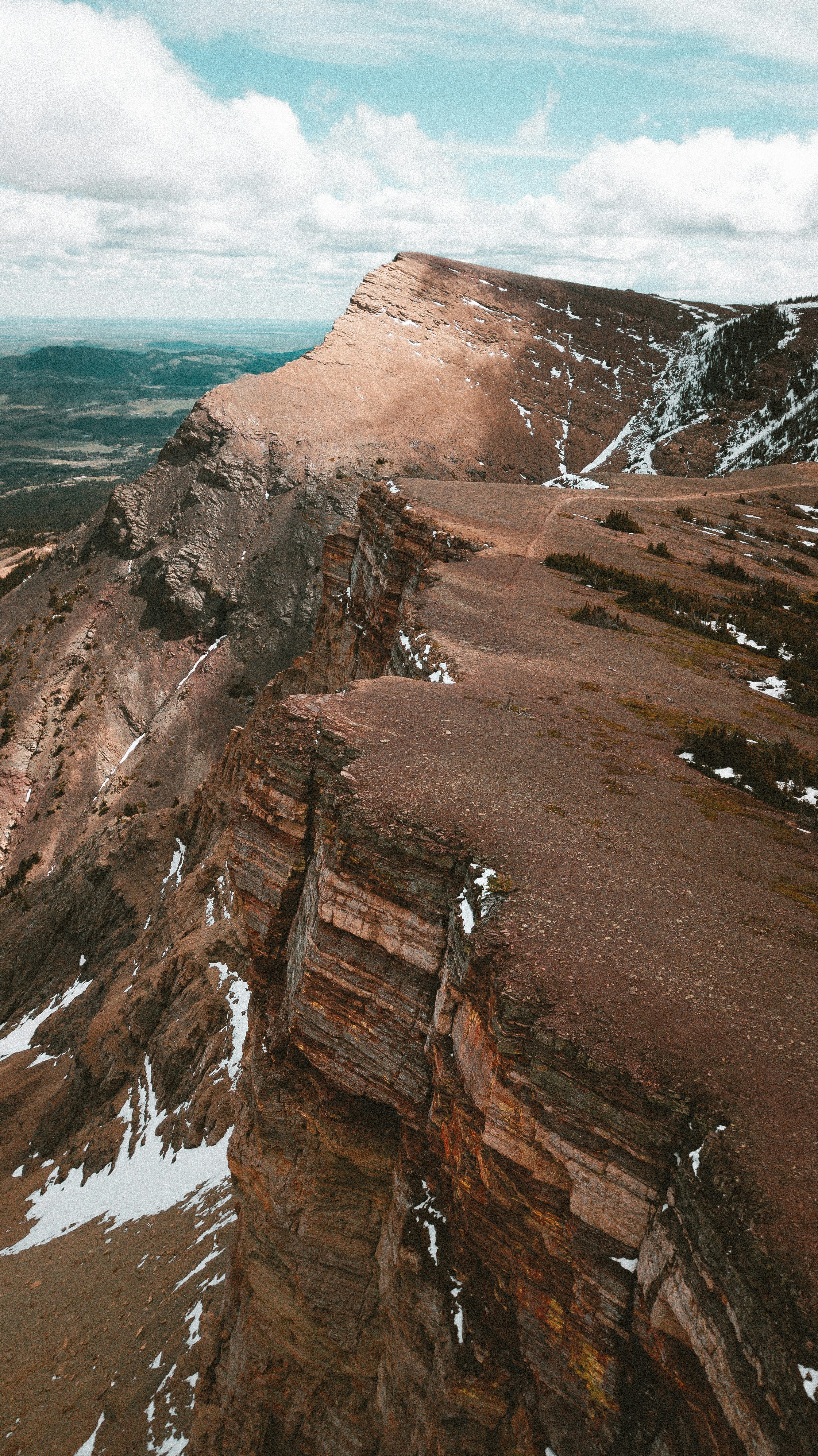A view of a rocky mountain with snow on it