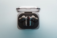 A pair of ear buds sitting in a case
