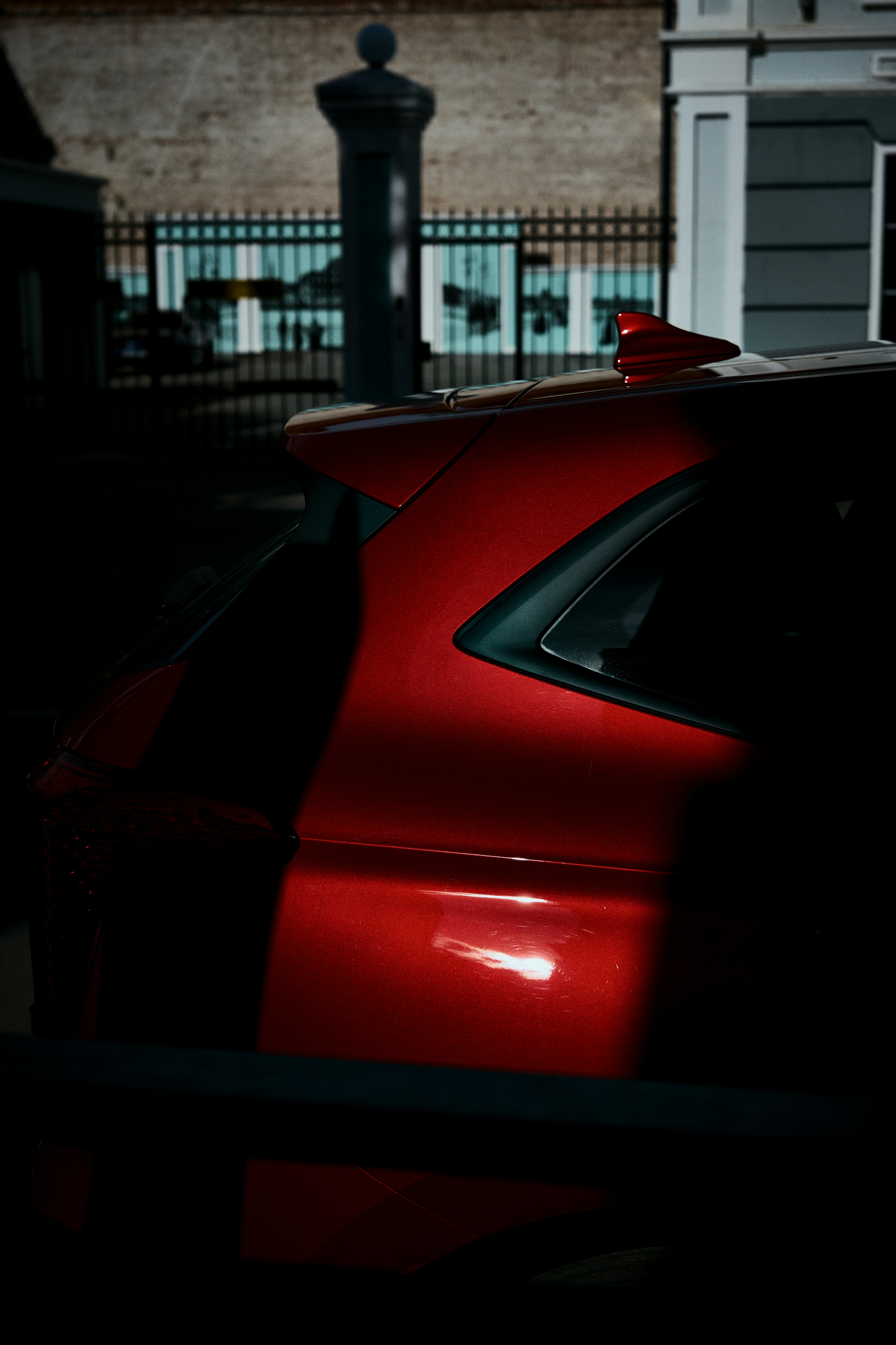 A red car parked in front of a building photo – Free Car Image on Unsplash