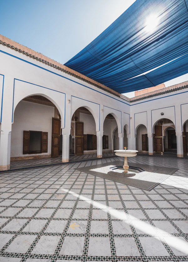 Arched arcades around the tiled courtyard and central fountain of the Bahia Palace in Marrakech