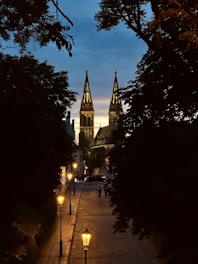 A city street with a church steeple in the background