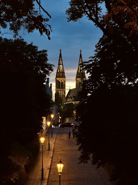 A city street with a church steeple in the background