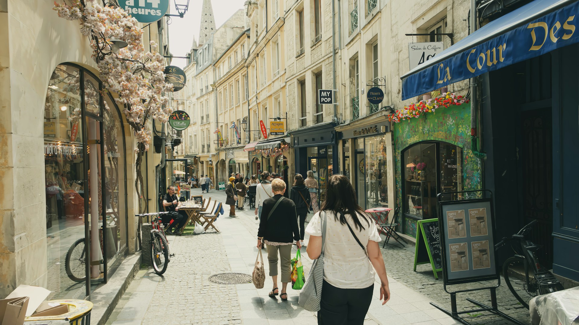 A couple of people that are walking down a street