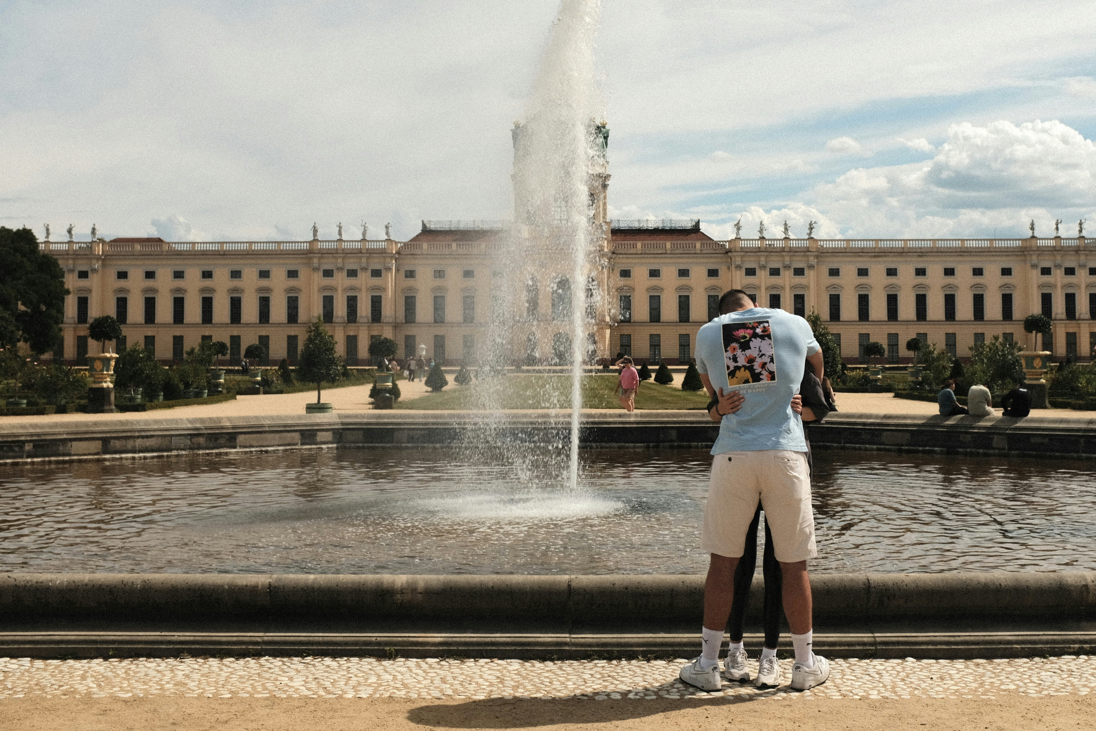 A man standing in front of a water fountain