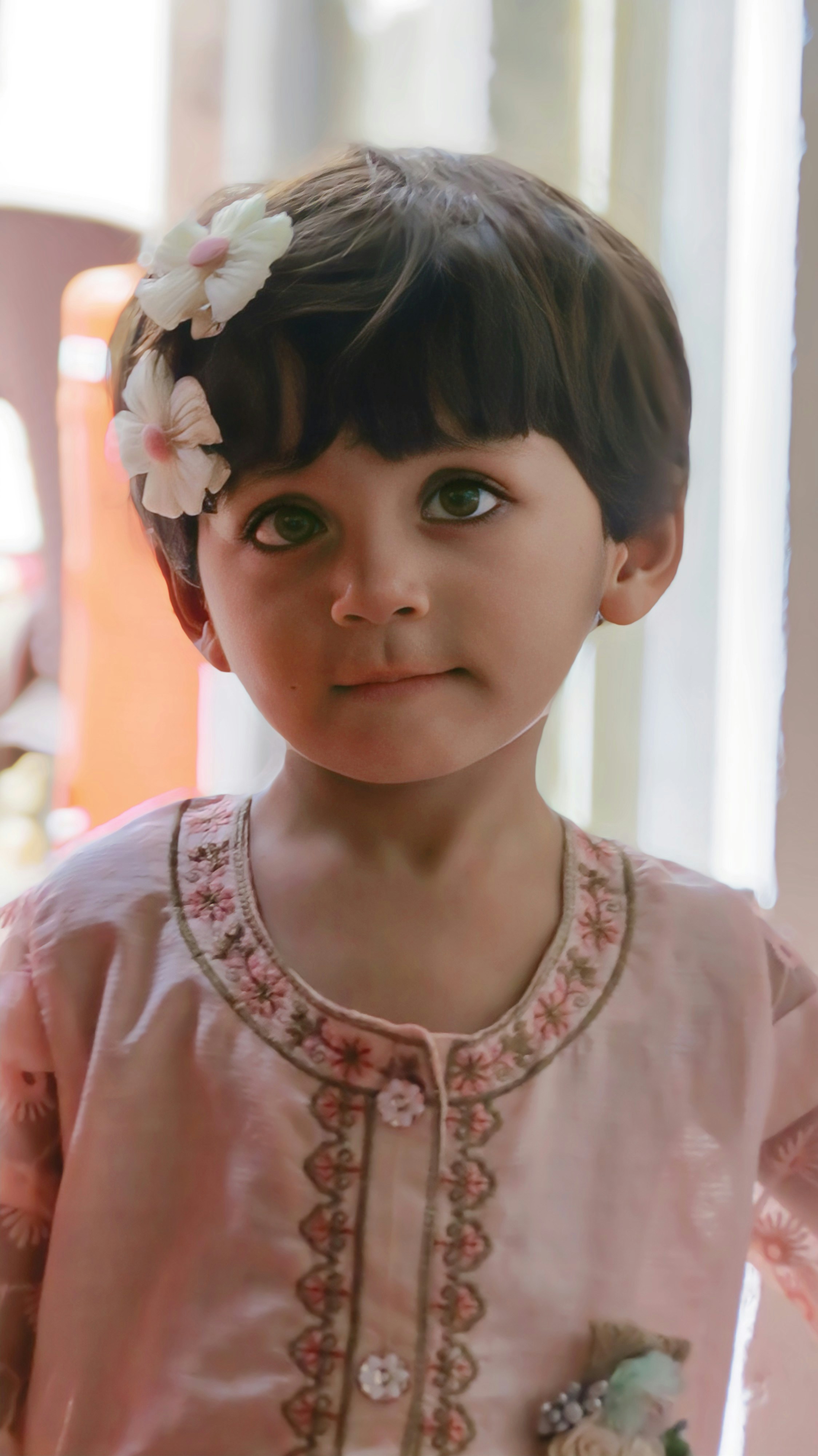 A little girl with a flower in her hair
