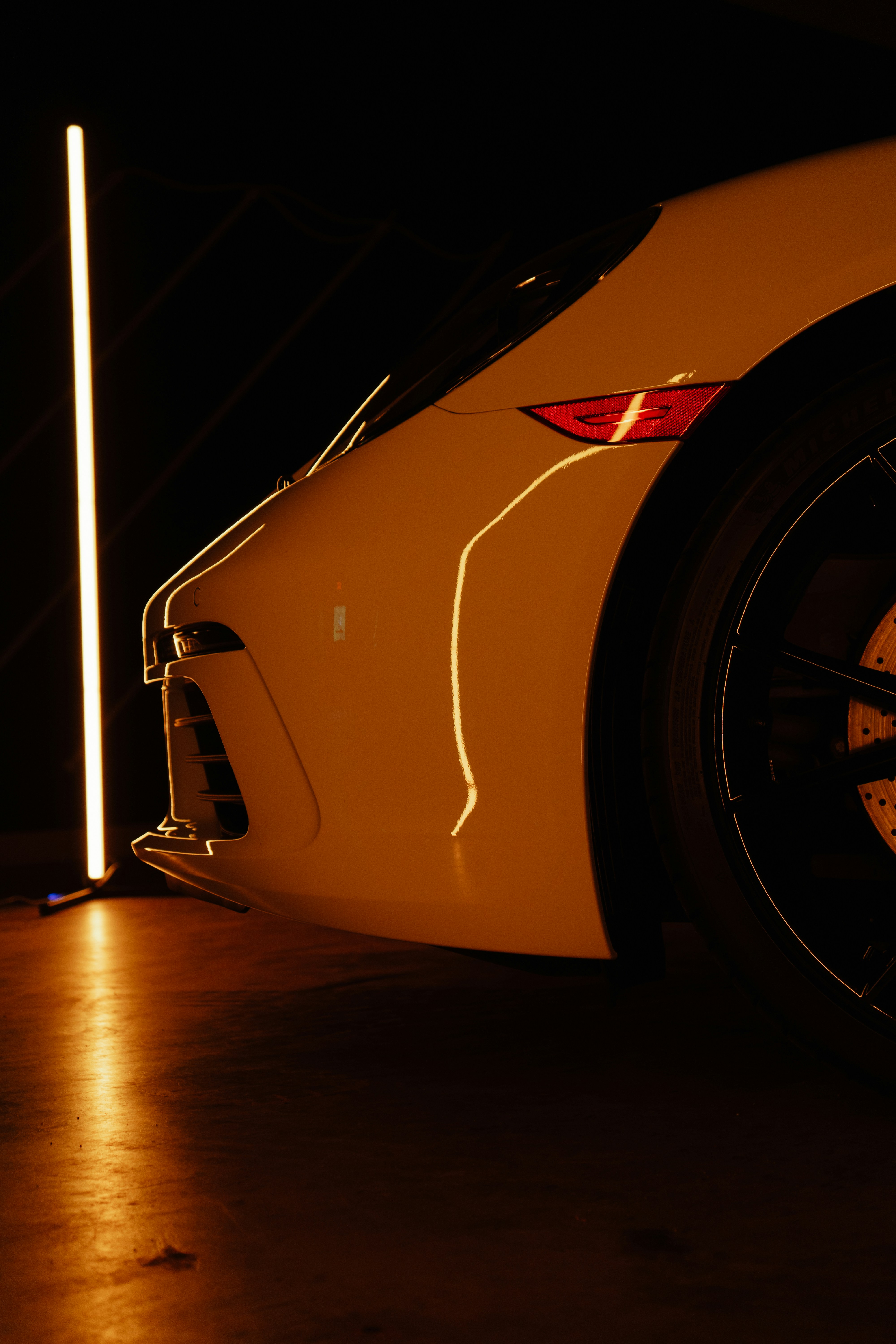 A white sports car parked in a garage