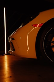 A white sports car parked in a garage