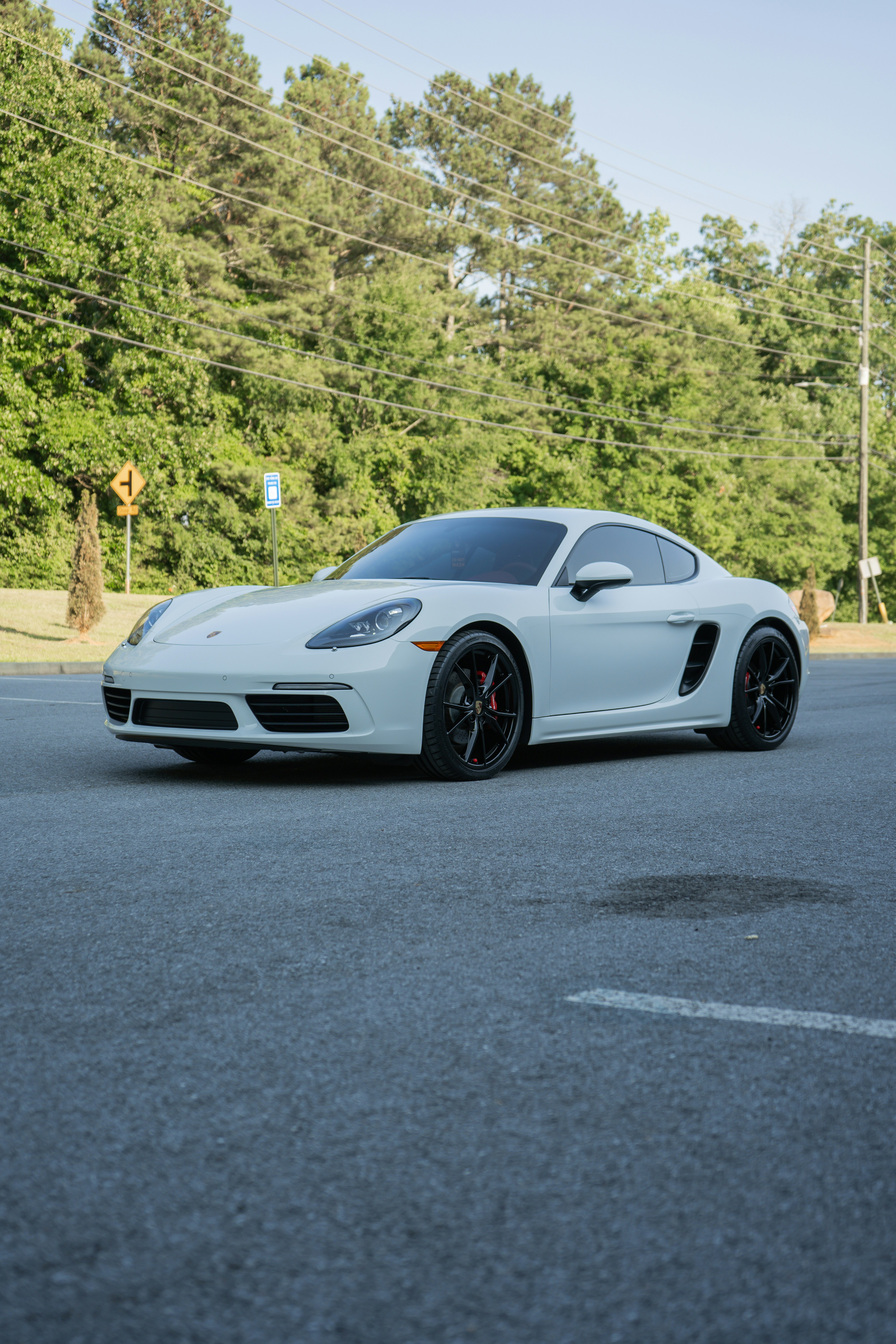A white sports car parked in a parking lot