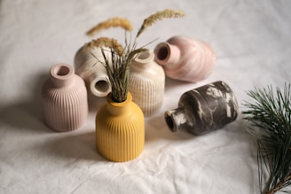 A group of vases sitting on top of a bed