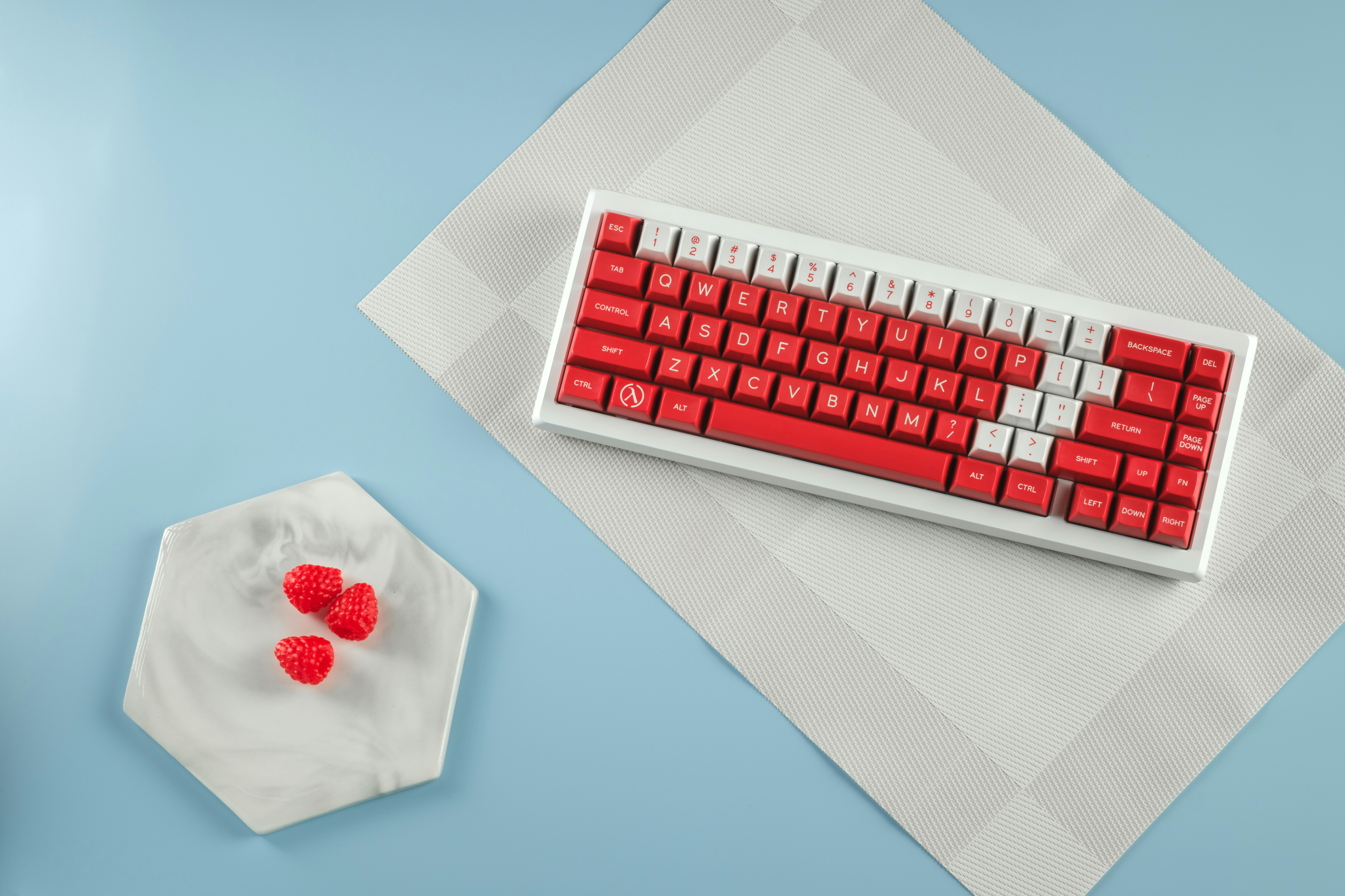 A computer keyboard and mouse on a blue surface
