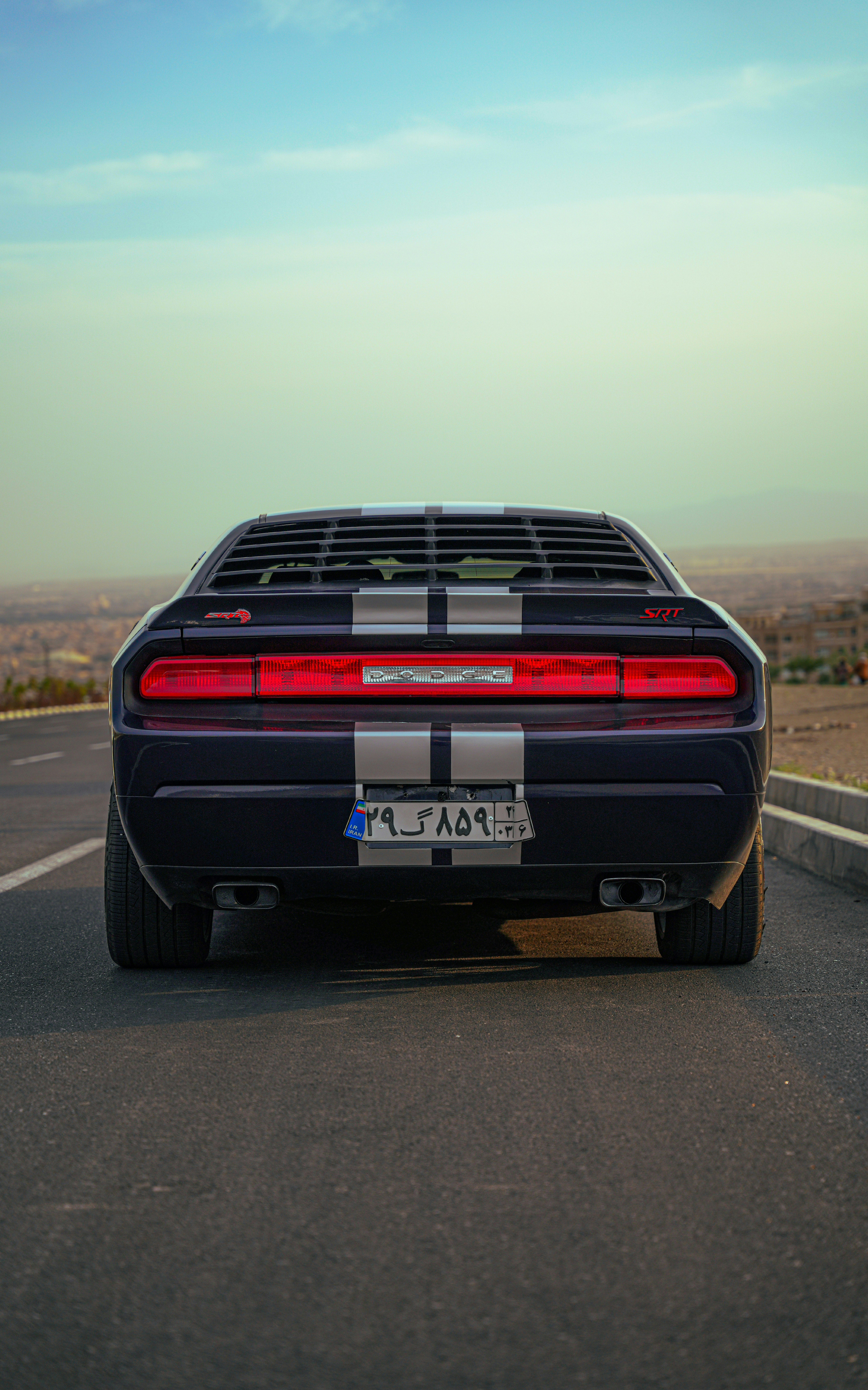 A black sports car driving down a highway