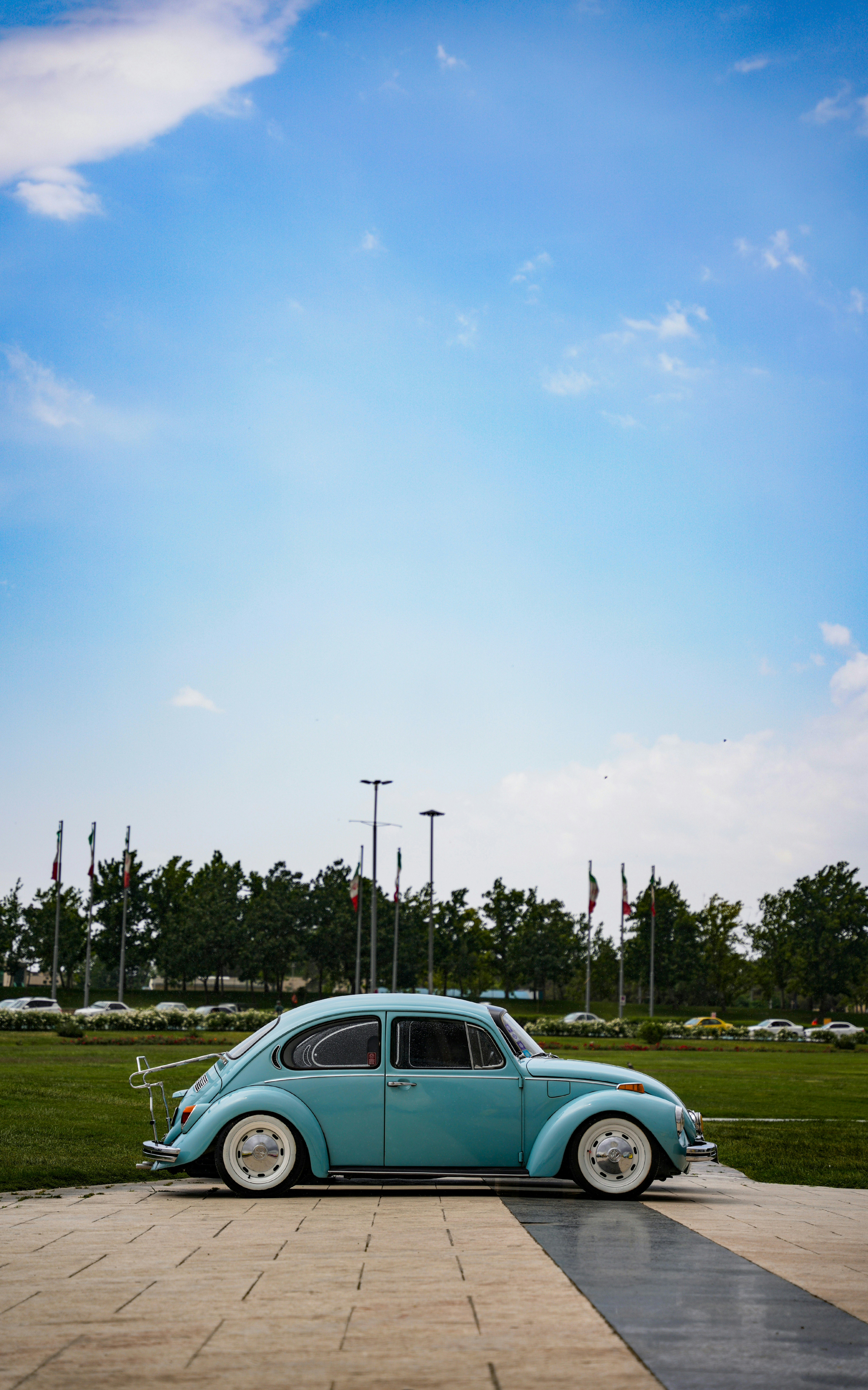 A small blue car parked in a parking lot