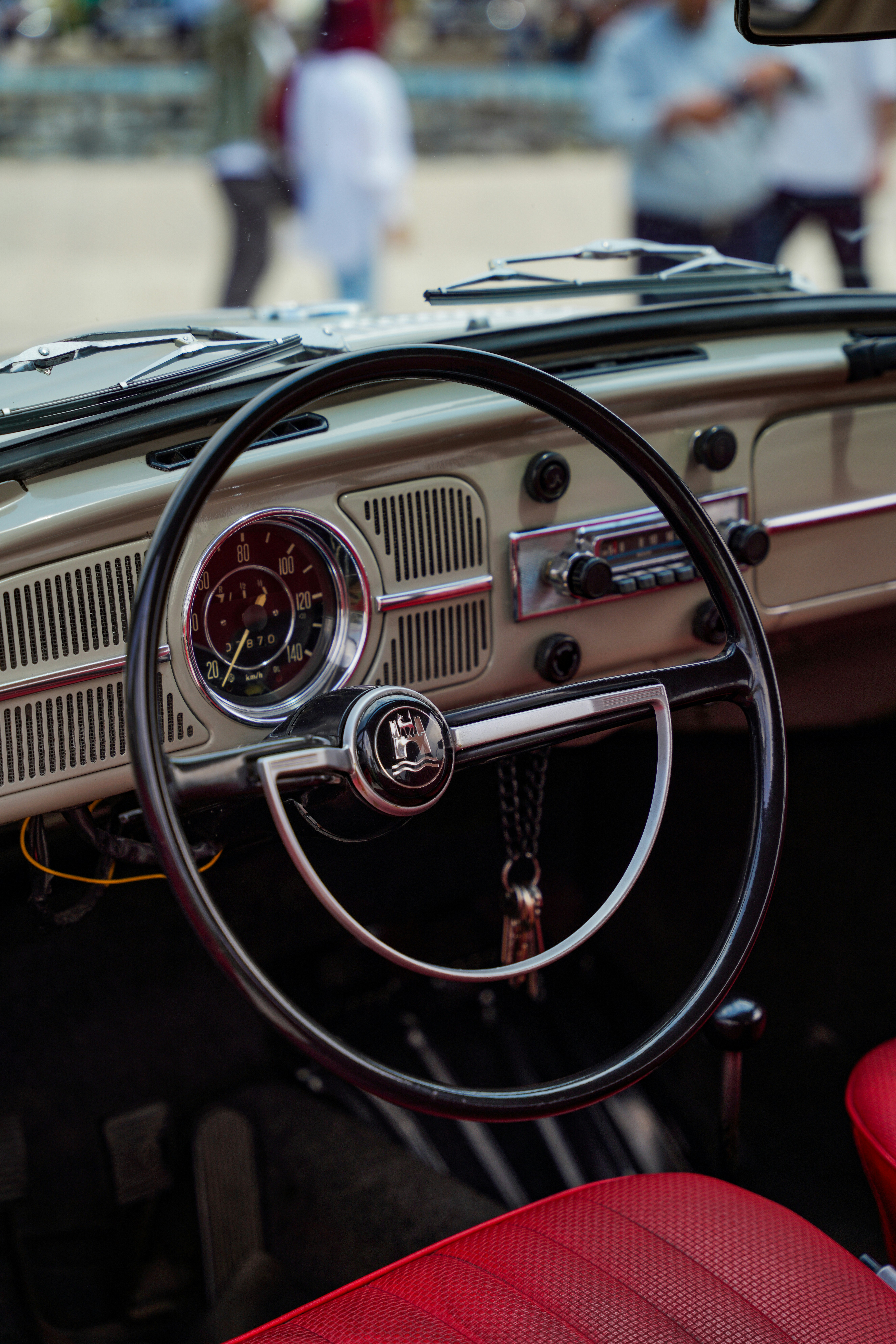 The dashboard of a car with a red leather seat