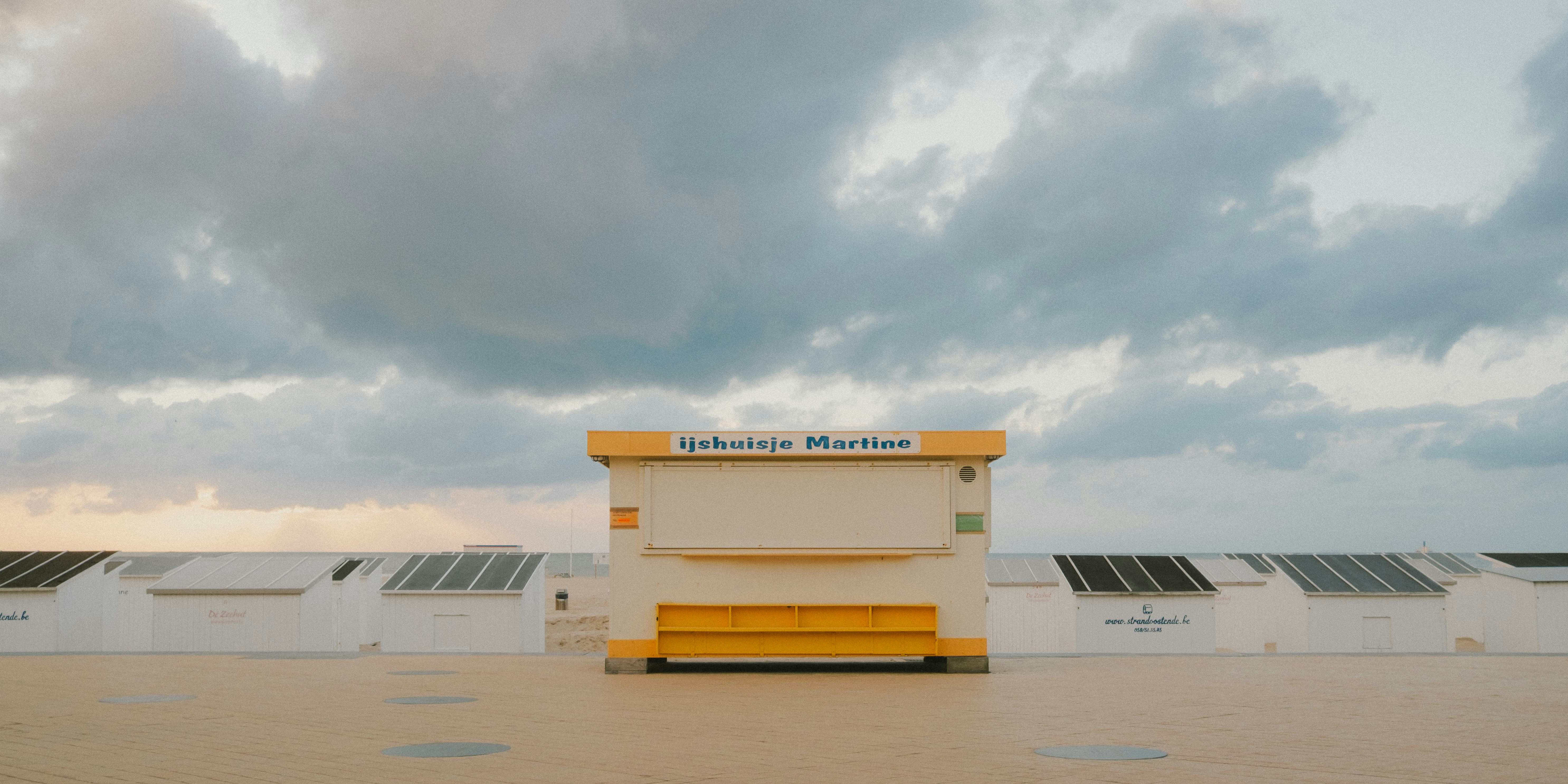 A beehive sitting on top of a roof under a cloudy sky