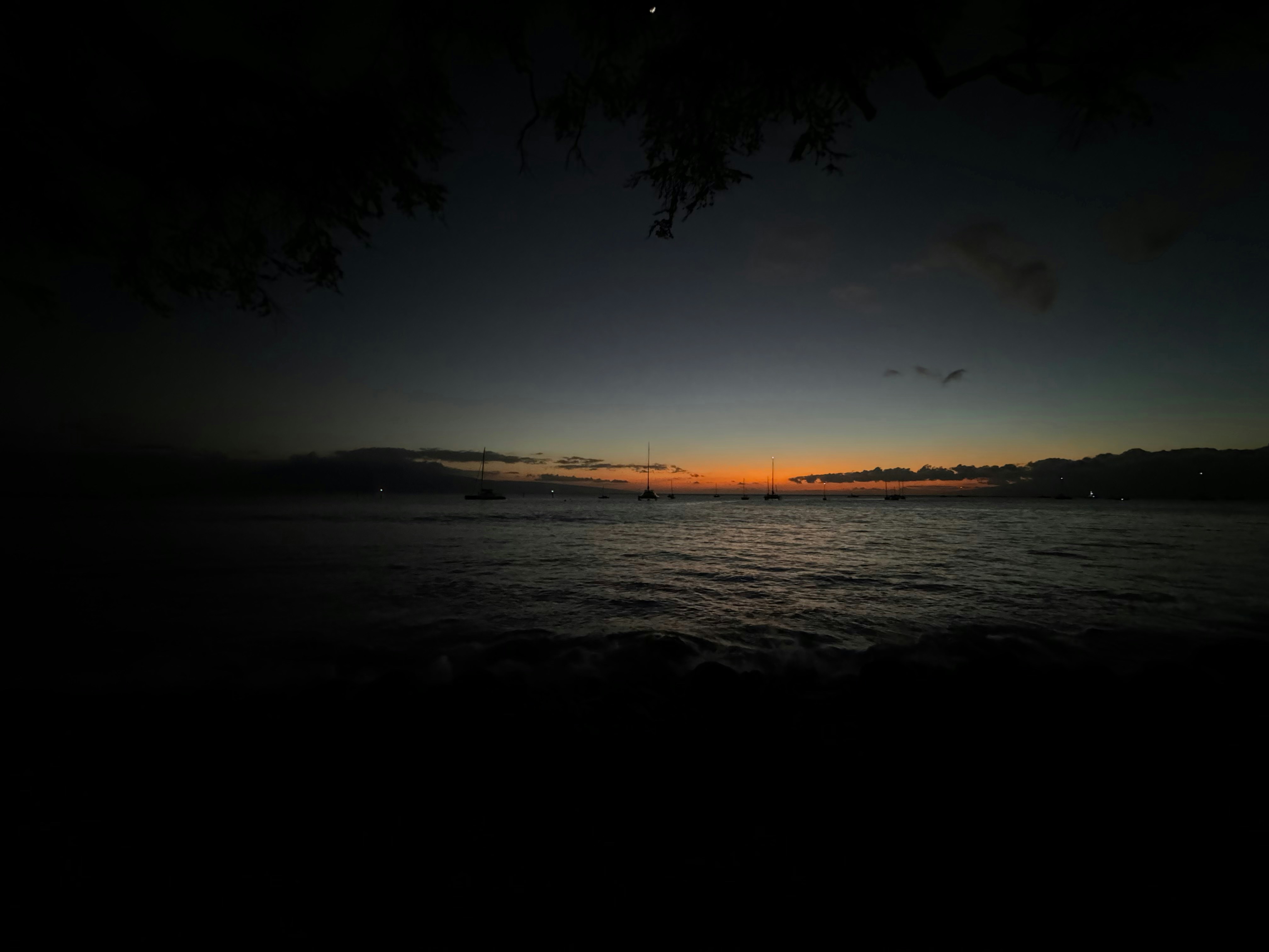 The sun is setting over a body of water