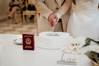 A newly married couple cutting their wedding cake