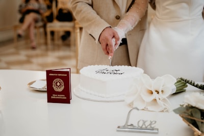 A newly married couple cutting their wedding cake