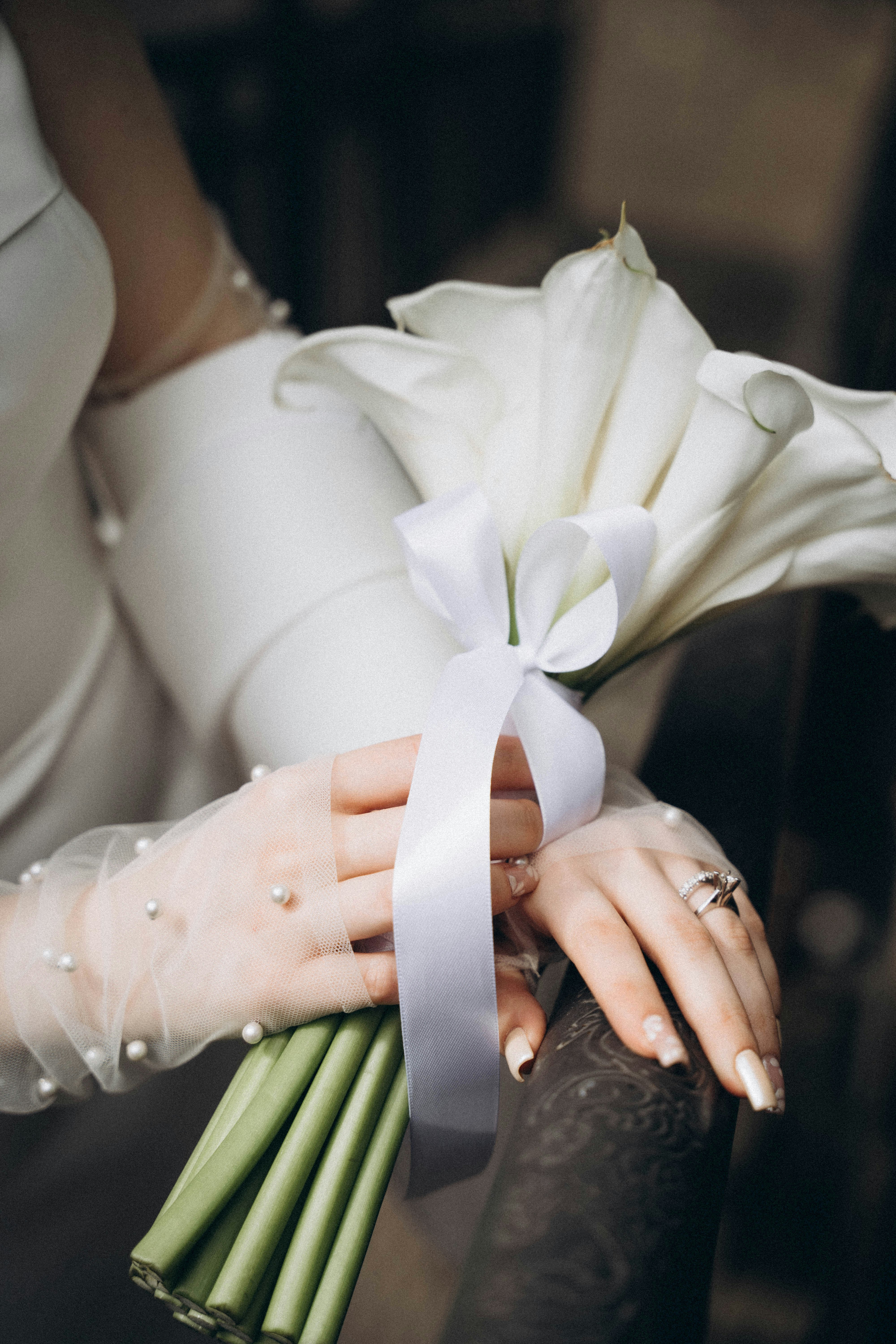 A woman in a white dress holding a bouquet of flowers