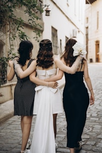 A group of women walking down a street next to each other