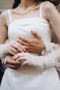 A woman in a white dress holding a man in a suit