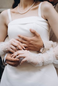 A woman in a white dress holding a man in a suit