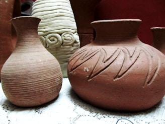 A group of three vases sitting on top of a table