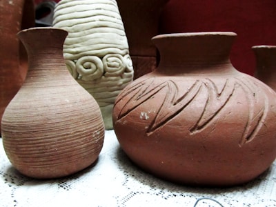 A group of three vases sitting on top of a table