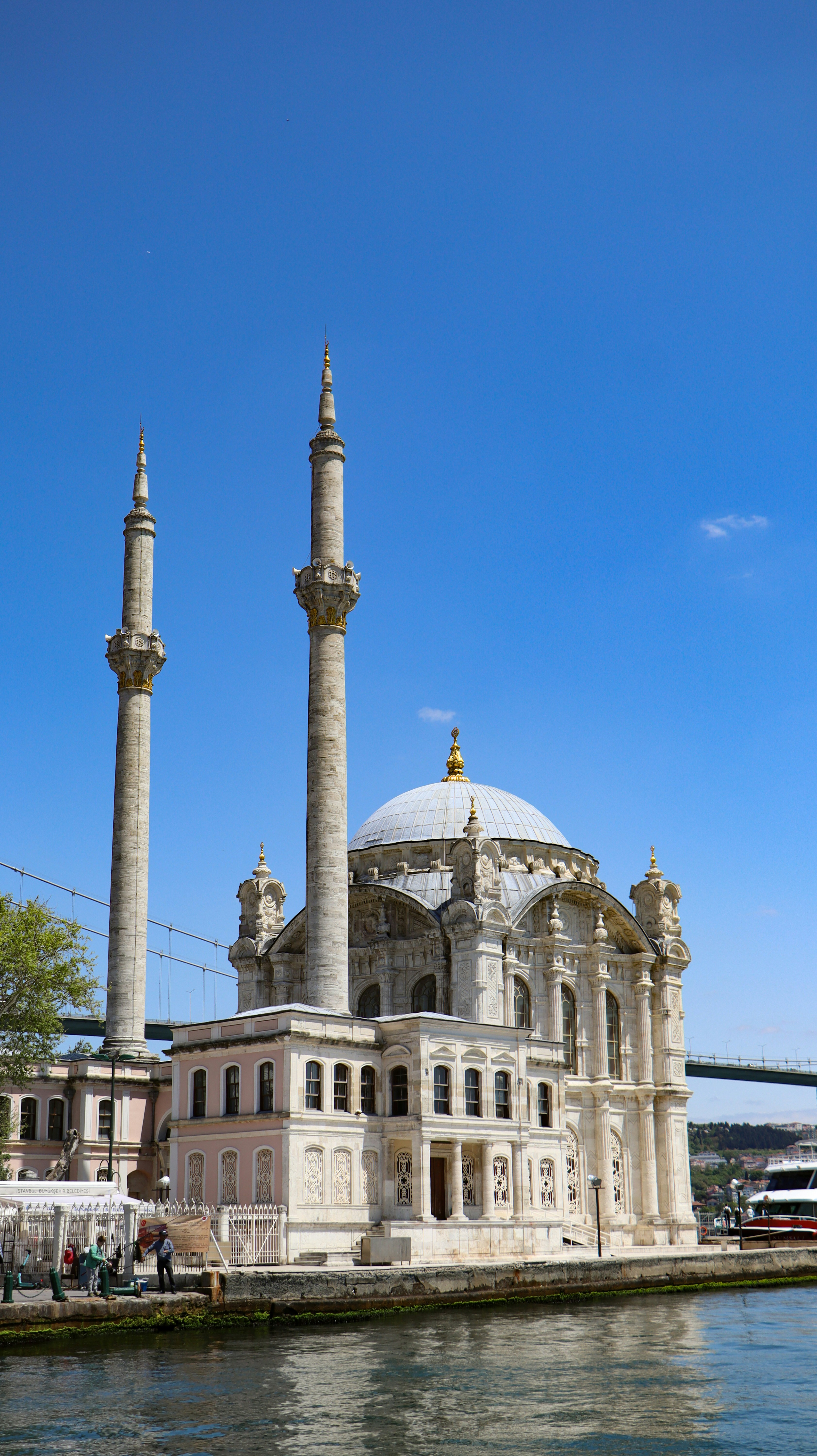 A large white building sitting next to a body of water