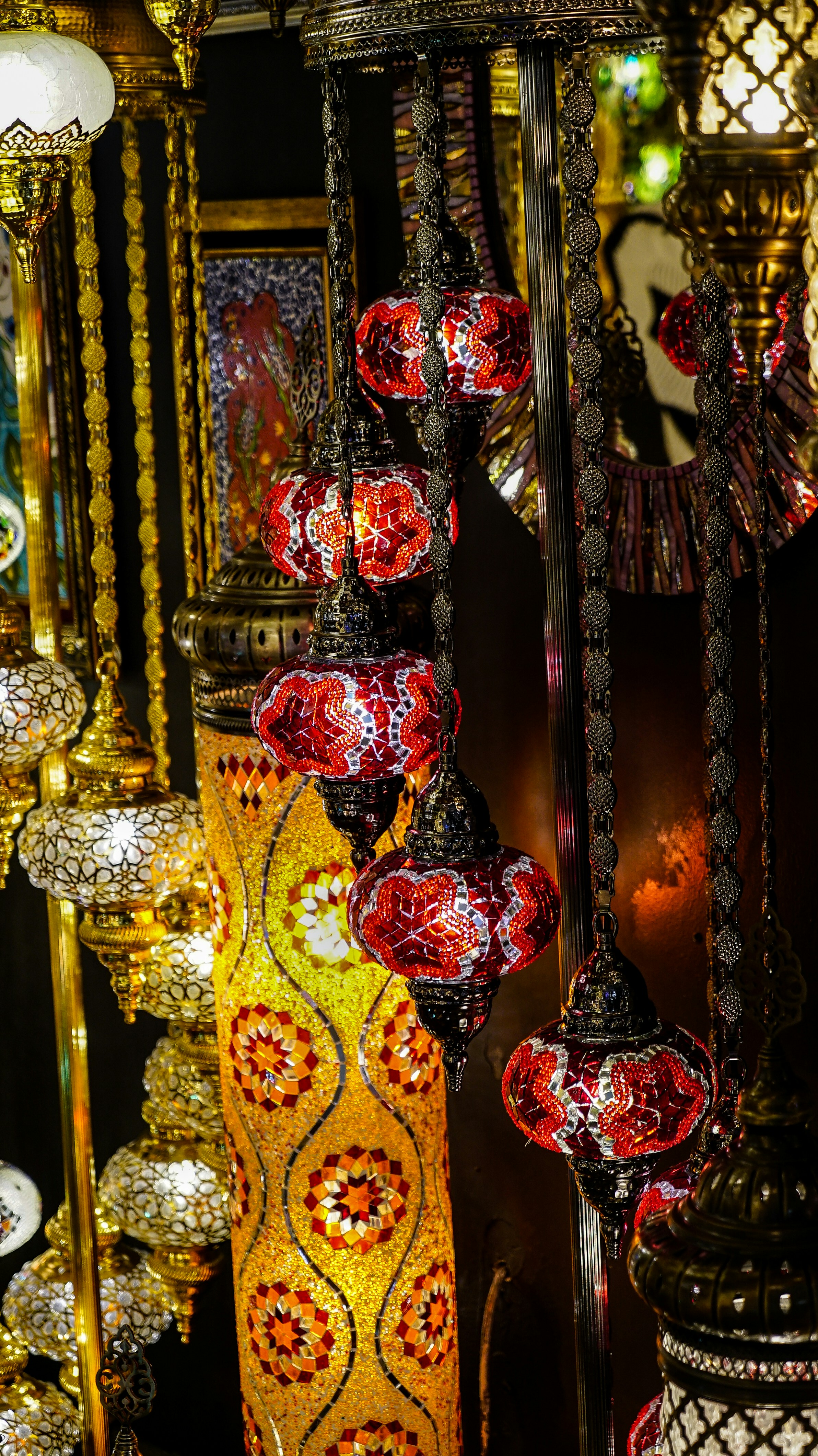 A number of different colored vases on a table