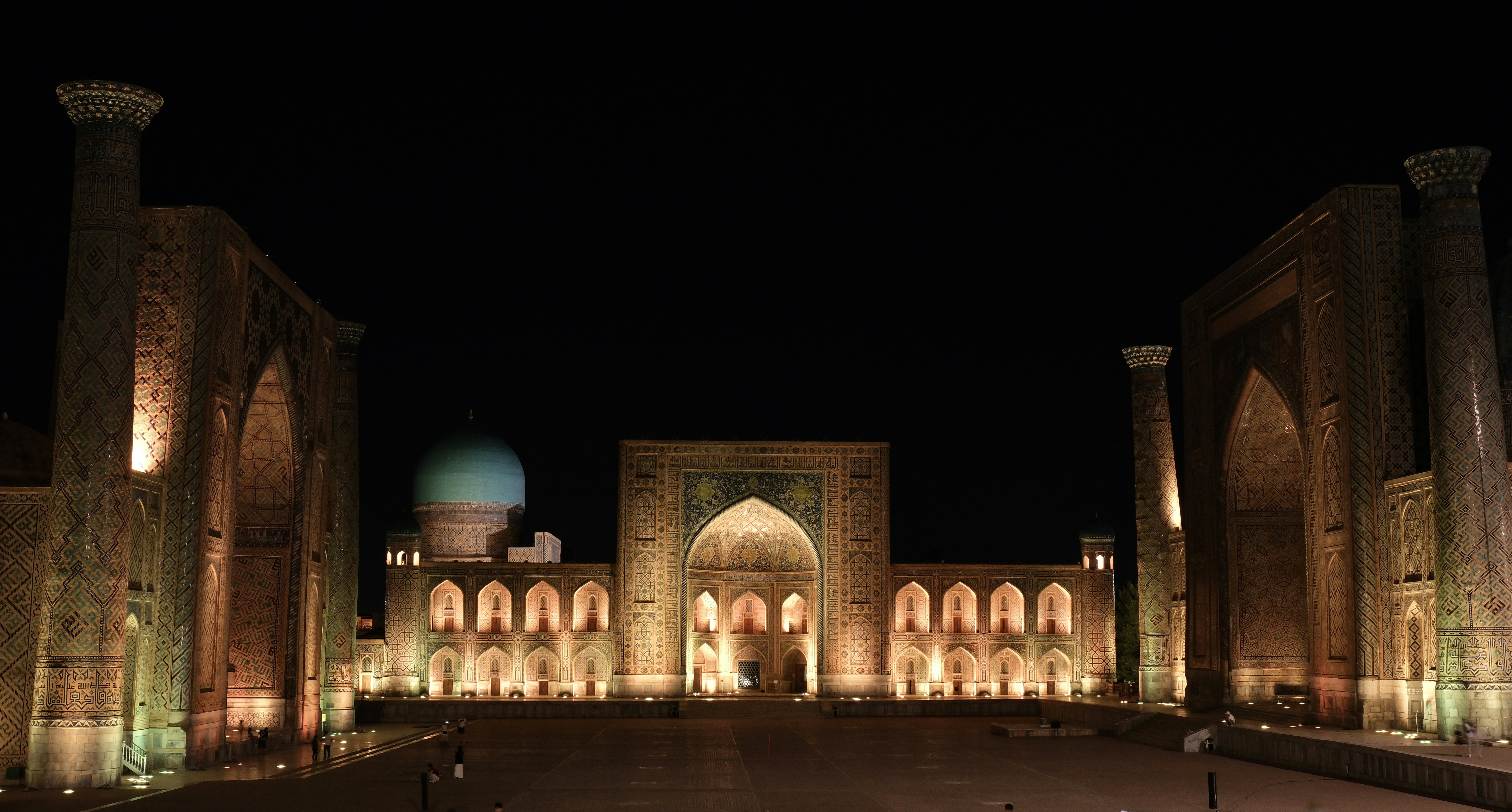 A large building lit up at night time