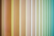 A multicolored striped wallpaper with vertical stripes