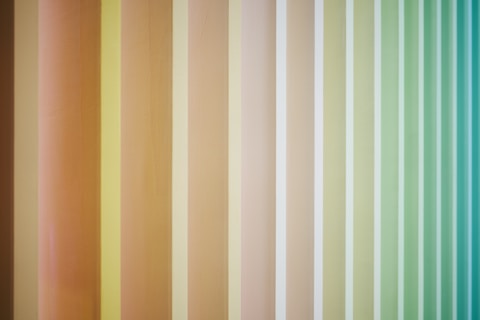A multicolored striped wallpaper with vertical stripes