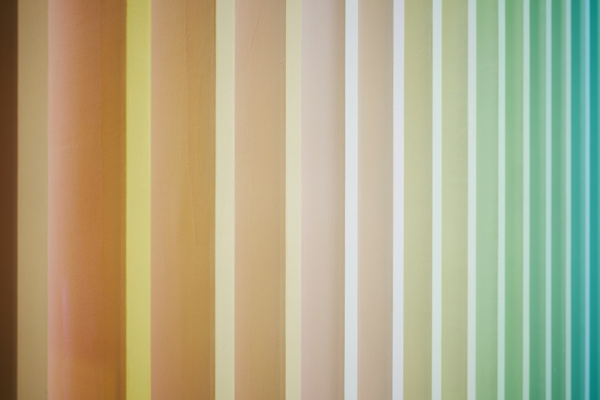 A multicolored striped wallpaper with vertical stripes