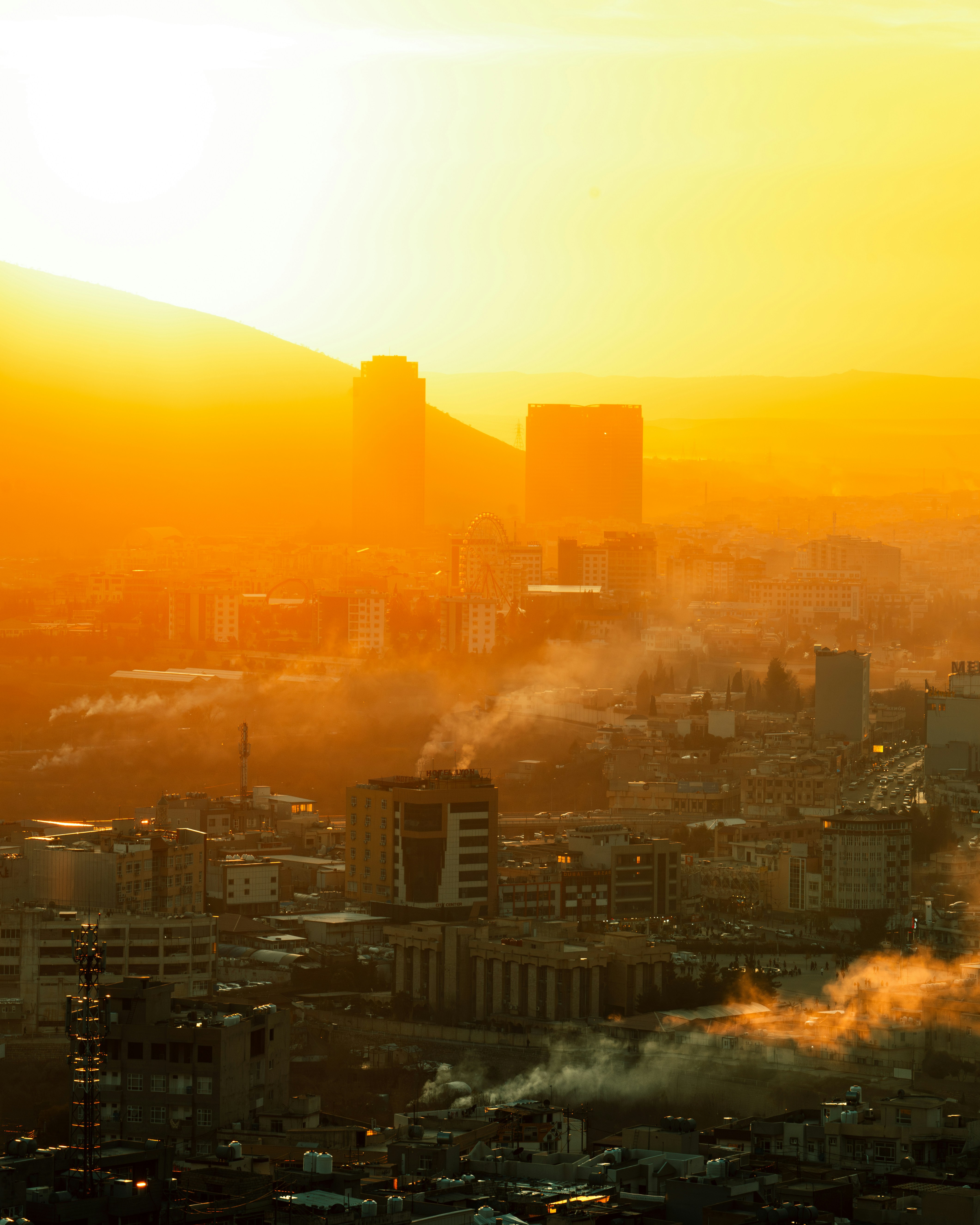 A view of a city at sunset from a tall building