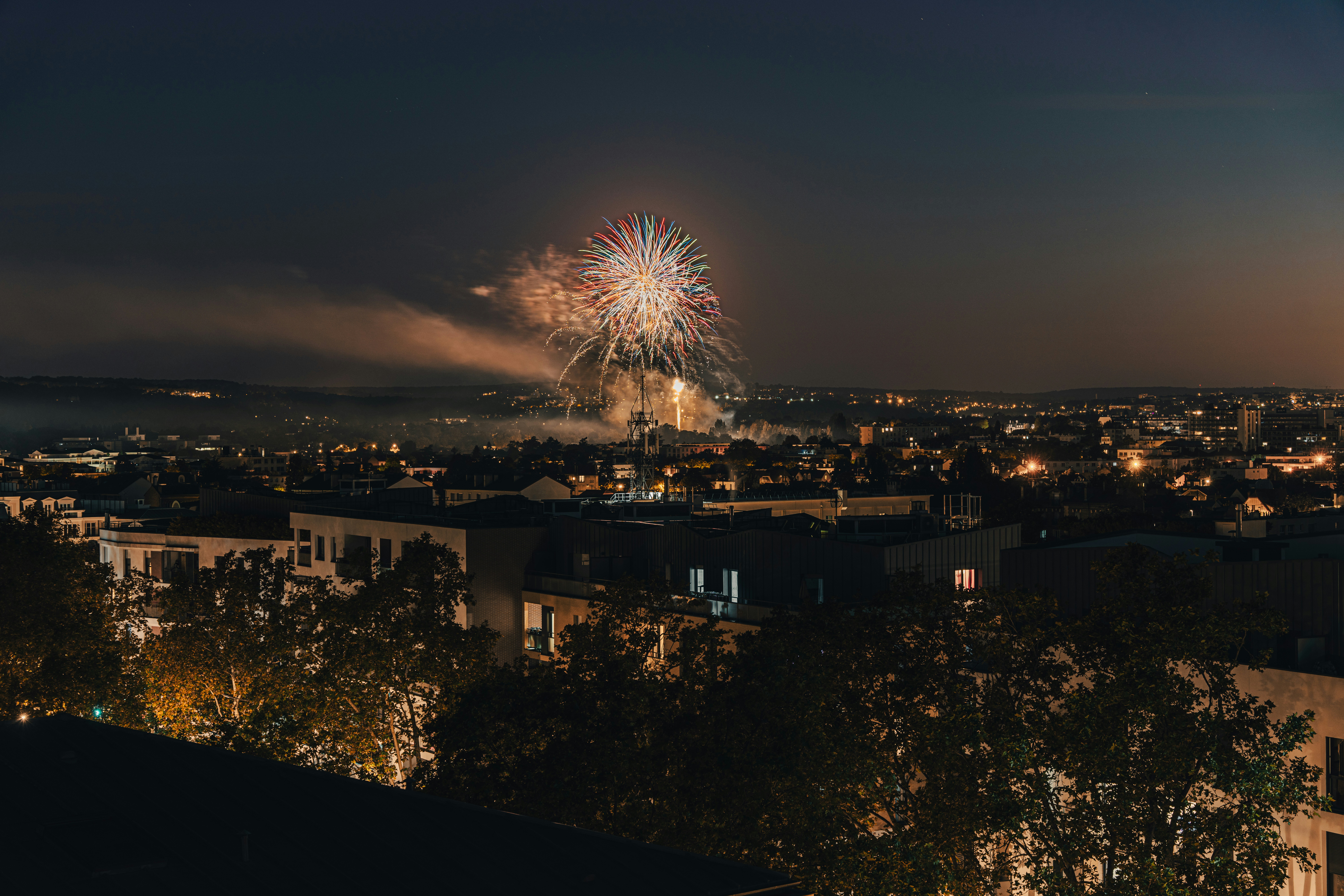 Un feu d’artifice au-dessus d’une ville la nuit