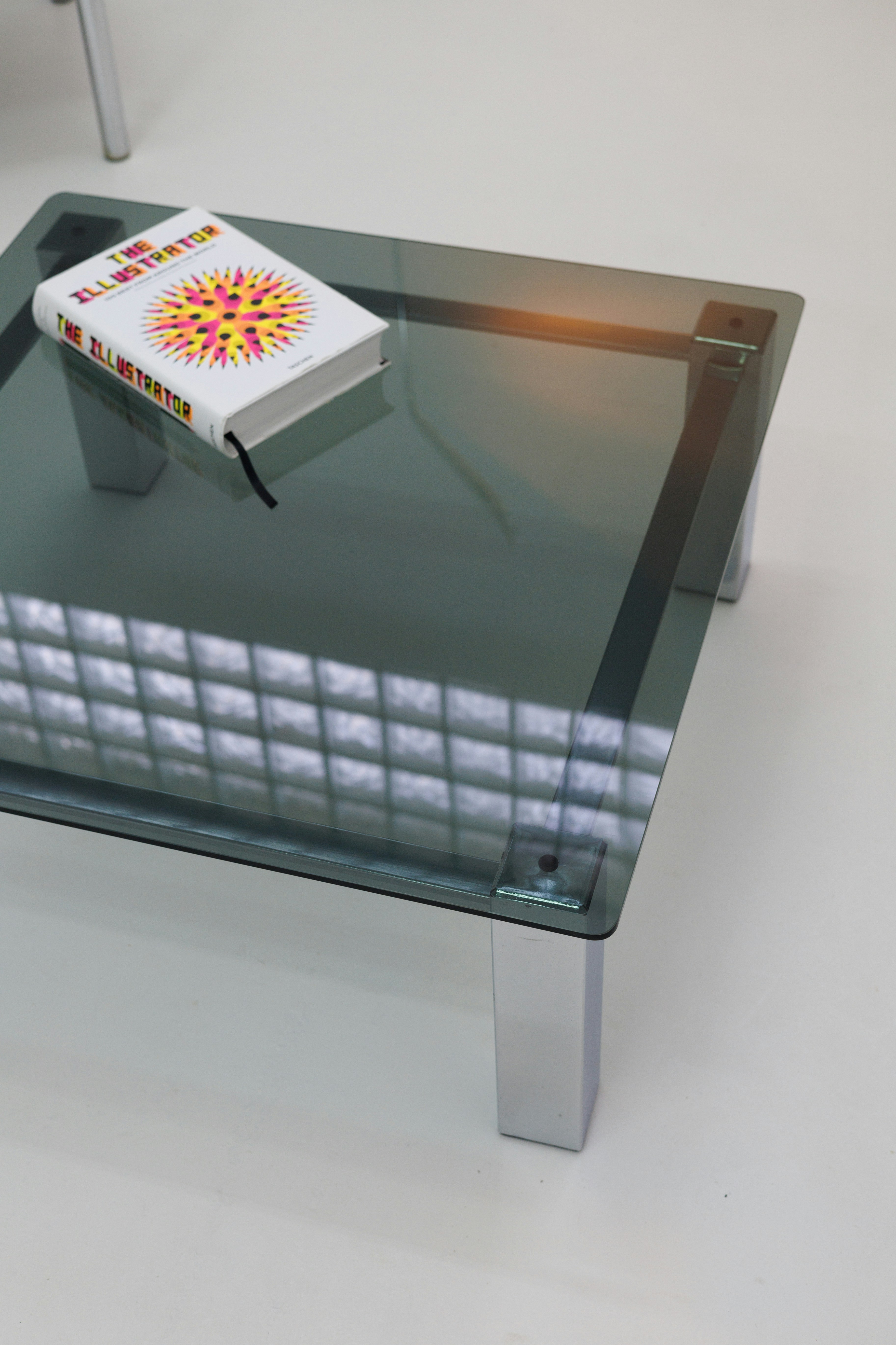A glass table with a book on top of it