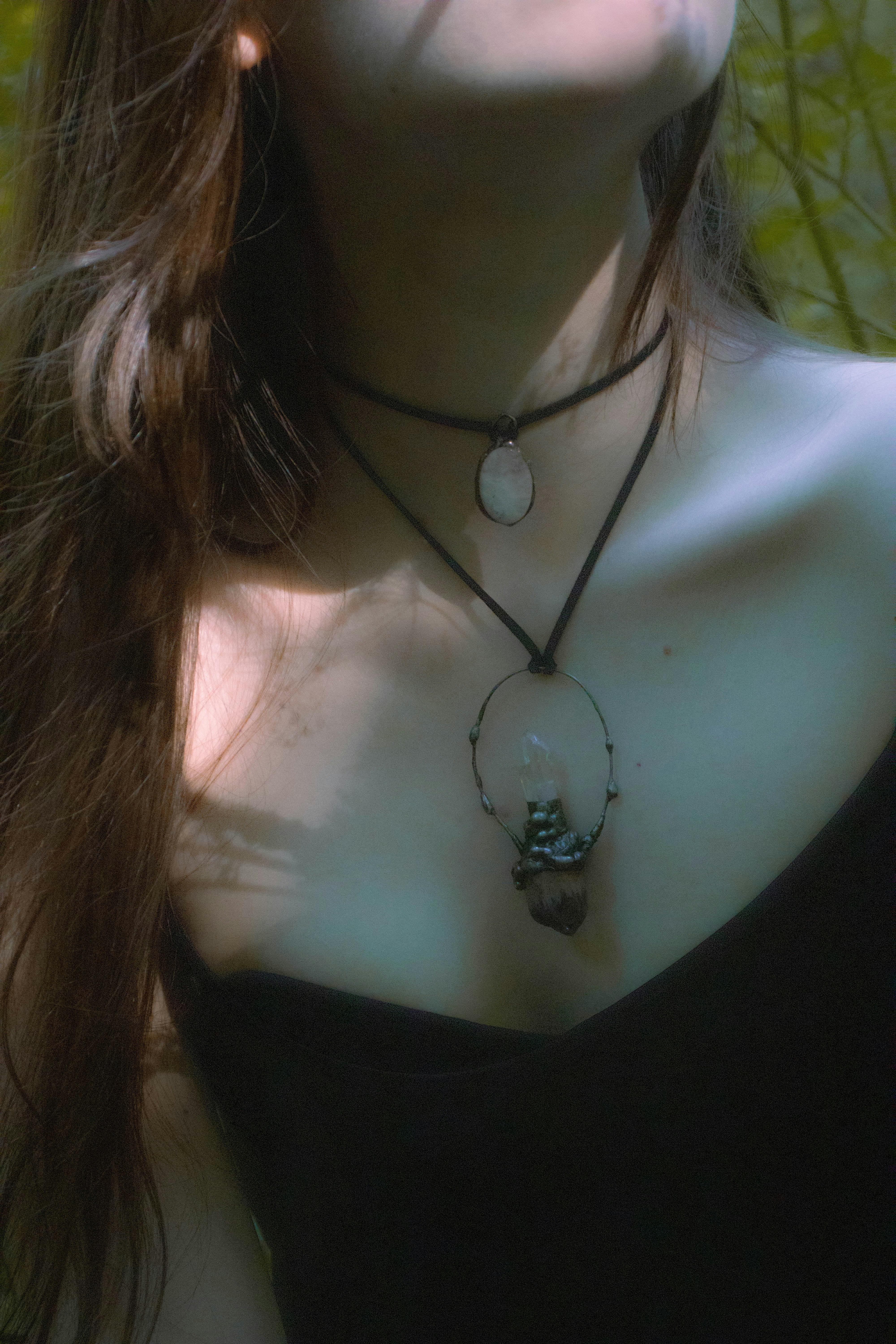 A woman with long hair wearing a necklace